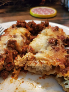 A picture of Stuffed Manicotti with Meat Sauce.