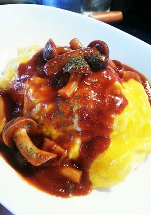 A picture of Fluffy and Creamy Omurice with Mushroom Demi-Glace Sauce.