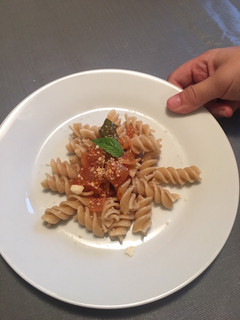 A picture of Whole grain fusilli pasta with tomato basil sauce.