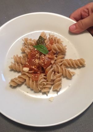 A picture of Whole grain fusilli pasta with tomato basil sauce.