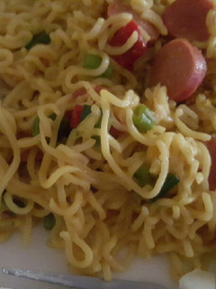 A picture of Noodles with sausages and boiled egg.