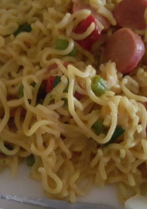 A picture of Noodles with sausages and boiled egg.