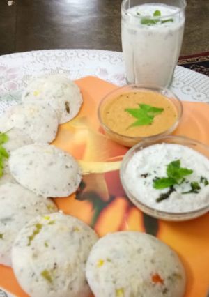 A picture of Veggie Idlis with coconut and red chutney.