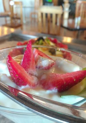 Una foto de Yogurth con granola y miel a las fresas