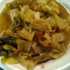 A picture of Bok Choy in a broth.