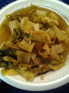A picture of Bok Choy in a broth.