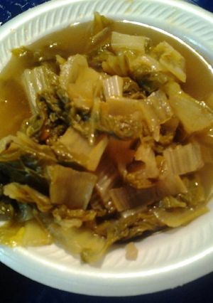 A picture of Bok Choy in a broth.