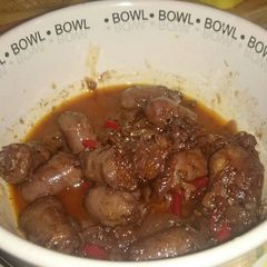 A picture of Chipolatas in Red Win Sauce.