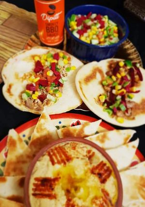 A picture of Shawarma with homemade hummus.