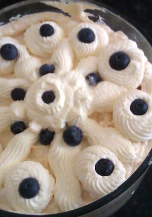 A picture of banana, blueberry and coconut trifle.