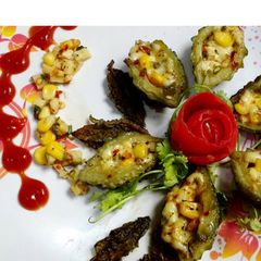 A picture of Bittergourd corn cheesy boat.