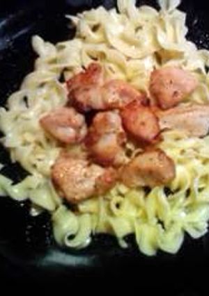 A picture of lemon pepper chicken and butter noodles.