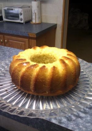 A picture of home made pound cake with side of strawberries.