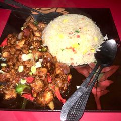 A picture of Dragon Chicken with egg fried rice.