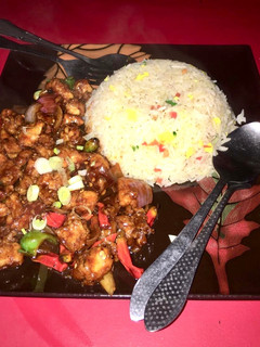 A picture of Dragon Chicken with egg fried rice.