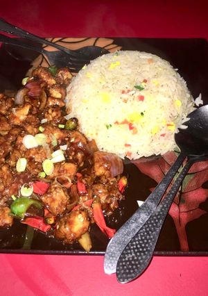 A picture of Dragon Chicken with egg fried rice.