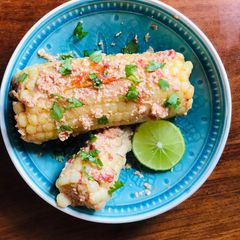 A picture of Corn on the cob in coconut sauce.