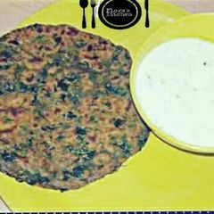 A picture of Soya methi ke parathe serve with curd.