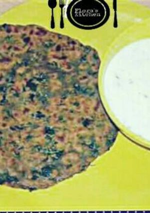 A picture of Soya methi ke parathe serve with curd.