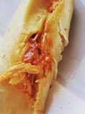 Tamales rojos en hoja de maíz