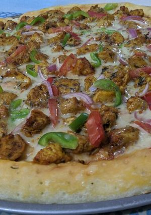 A picture of Chicken Tikka pizza.
