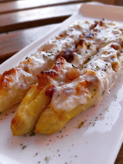 Una foto de Espárragos blancos gratinados rellenos de panceta ibérica y nueces