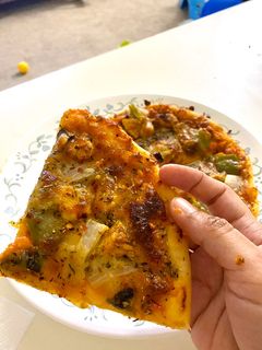 A picture of Chicken Tikka Pizza.