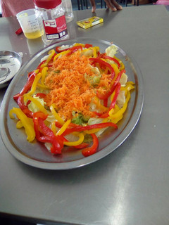 A picture of Lettuce, carrot and yellow, red pepper salad.