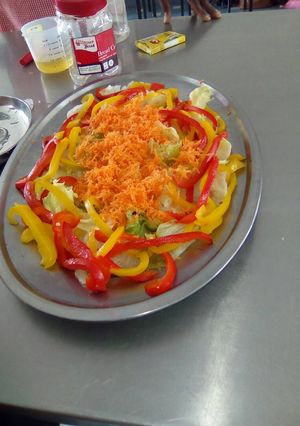 A picture of Lettuce, carrot and yellow, red pepper salad.