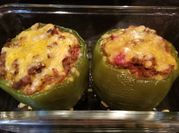 A picture of cheesy stuffed green bell peppers