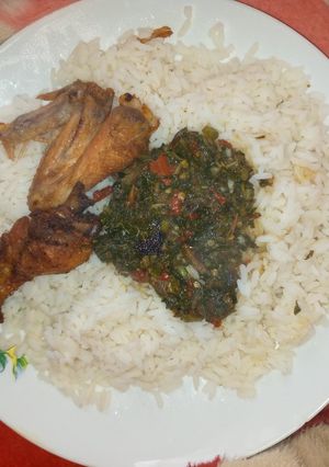 A picture of White rice with vegetable soup nd fried chicken.