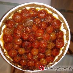 A picture of Tart with Cretan dakos and cherry tomatoes.