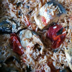 A picture of Jollof rice with fresh Titus fish.