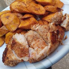 A picture of Grilled chicken breast with fried plantain.