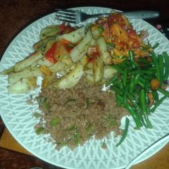A picture of Potato wedges served with minced meat, fried French beans and kachumbari.