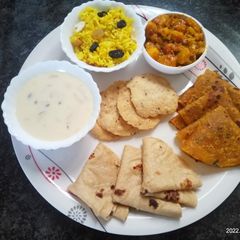 A picture of Milk custard with puri and thepla.