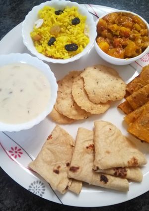 A picture of Milk custard with puri and thepla.