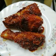 A picture of Honey and ketchup glanced chicken drumsticks.