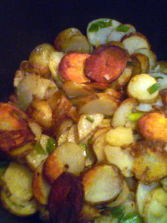 A picture of Smothered potatoes with green onions.