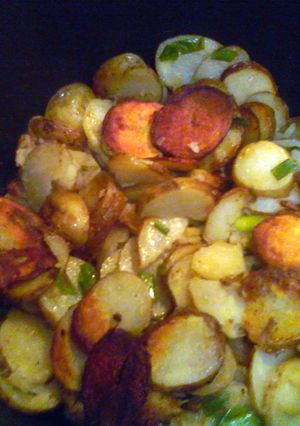 A picture of Smothered potatoes with green onions.