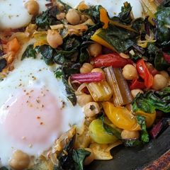 One-pan egg, tomato, chard + cumin brunch A picture of One-pan egg, tomato, chard + cumin brunch.