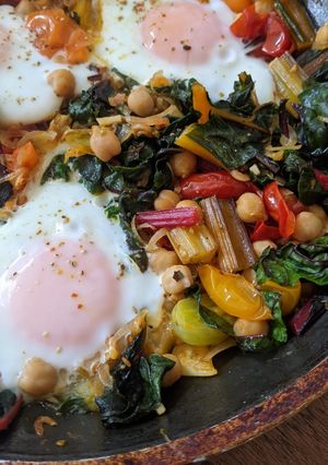 A picture of One-pan egg, tomato, chard + cumin brunch.