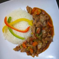 A picture of Beef stew served with rice #AuthorMarathon.