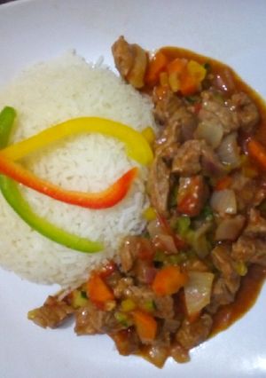 A picture of Beef stew served with rice #AuthorMarathon.
