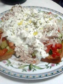 A picture of Ladopsomo with Tzatziki Sauce.
