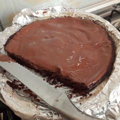 A picture of Brownies with ganache.