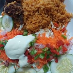 A picture of Simple party jollof rice with salad.