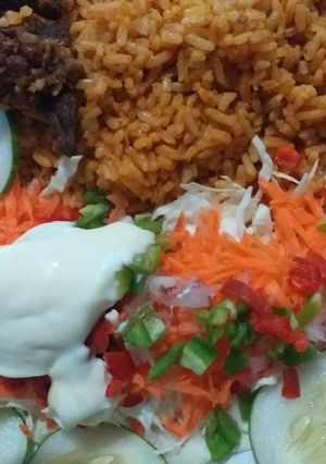 A picture of Simple party jollof rice with salad.