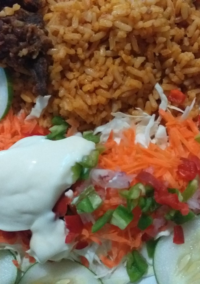A picture of Simple party jollof rice with salad.