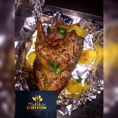 A picture of Oven Grilled full Chicken with garnish.